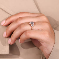 Buy diamond ring with pear cut centre and cluster design.