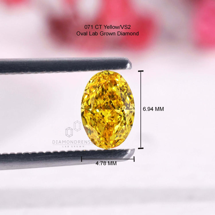 Oval diamond in vivid yellow tone is IGI certified and lab grown.