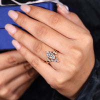 Three stone style highlights the marquise cut center stone.