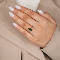 Green Dutch marquise diamond ring with a six leaf style prong setting.