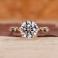 Round diamond engagement ring with milgrain setting.