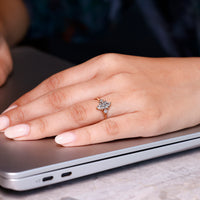 Three diamond engagement ring with a marquise centre stone and round side diamonds, perfect for those who love symmetry.