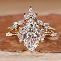 Marquise wedding ring with round side stones and vintage style.