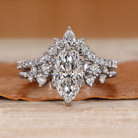 Marquise wedding ring with round side stones and prongs.