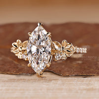 Handmade marquise engagement ring with flower design and pave band.