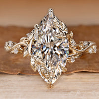 Marquise diamond ring with round side stones.