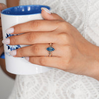 Blue marquise engagement ring with a tulip setting.