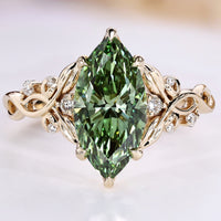 Nature-inspired engagement ring with a green marquise center stone.