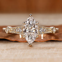 Marquise diamond ring with vintage style and milgrain details.