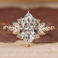 Nature inspired engagement ring featuring marquise diamond and art deco design.