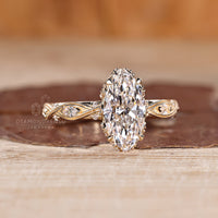 Marquise Diamond Ring with engraved filigree and round diamond accents.