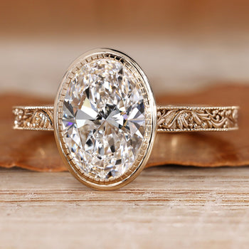 Oval lab grown diamond ring with bezel setting.