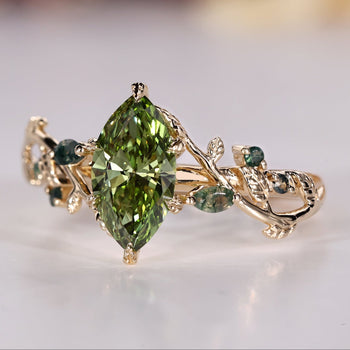 Green marquise engagement ring with Moss Agate side stones.
