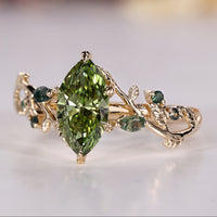 Green marquise engagement ring with Moss Agate side stones.
