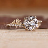Leaf design ring with round old european cut diamond and pave setting.