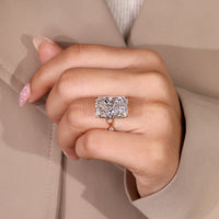 Handmade radiant cut diamond ring with four leaf style prong.