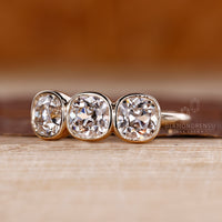 Cushion old european center diamond with smooth bezel setting.