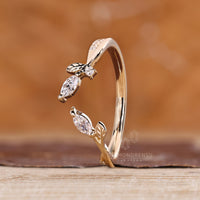Nature inspired band with marquise stone and pave detailing.