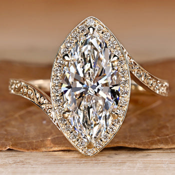 Marquise diamond ring with round diamond halo style.