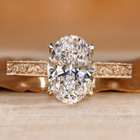 Art Deco engagement ring with oval center stone and milgrain details.