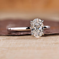 Handmade oval diamond ring with round cut hidden halo.