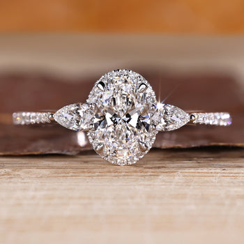 Oval cut lab grown diamond ring with pear side stones.
