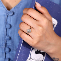 Vintage style three diamond ring with tapered shank and basket setting.