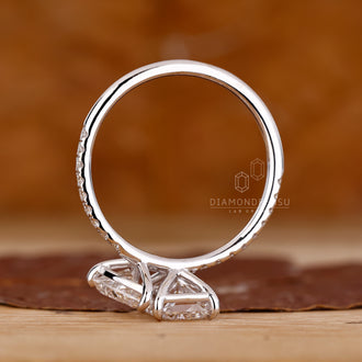 Diamondrensu engagement ring with pear and radiant diamonds, set in a white gold band for a secure fit.