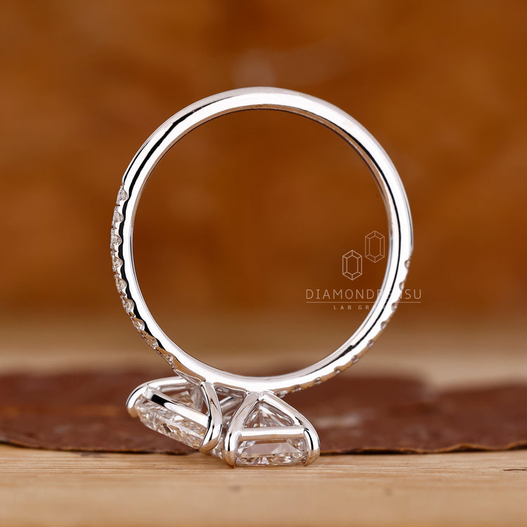 Diamondrensu engagement ring with pear and radiant diamonds, set in a white gold band for a secure fit.