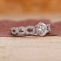 Close-up of a round cut diamond set in a 6 prong claw setting.