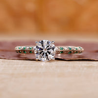 Two Tone Diamond Ring featuring a round cut diamond in a four prong ring setting.