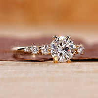 Prong Setting Engagement Ring with round diamonds set in yellow gold.