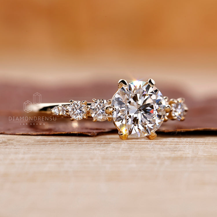 Prong Setting Engagement Ring with round diamonds set in yellow gold.