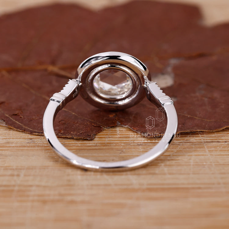 Diamondrensu engagement ring with round side stones in white gold.
