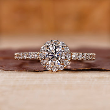 IGI certified round cut halo ring with prong setting.