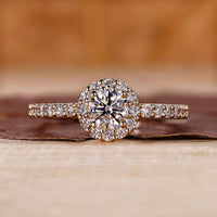 IGI certified round cut halo ring with prong setting.