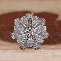 Cluster engagement ring featuring round diamonds in white gold setting.