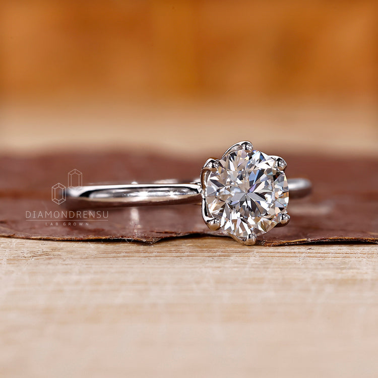 A solitaire diamond ring shines with brilliance.