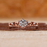 Round cut diamond engagement ring with rose gold band.