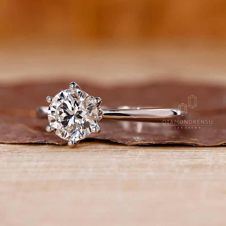 White gold ring featuring a round cut diamond, handmade for couples who want a classic and reliable design.