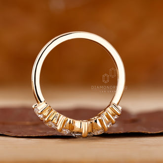 Diamondrensu wedding band with curved fit and 7 diamonds.