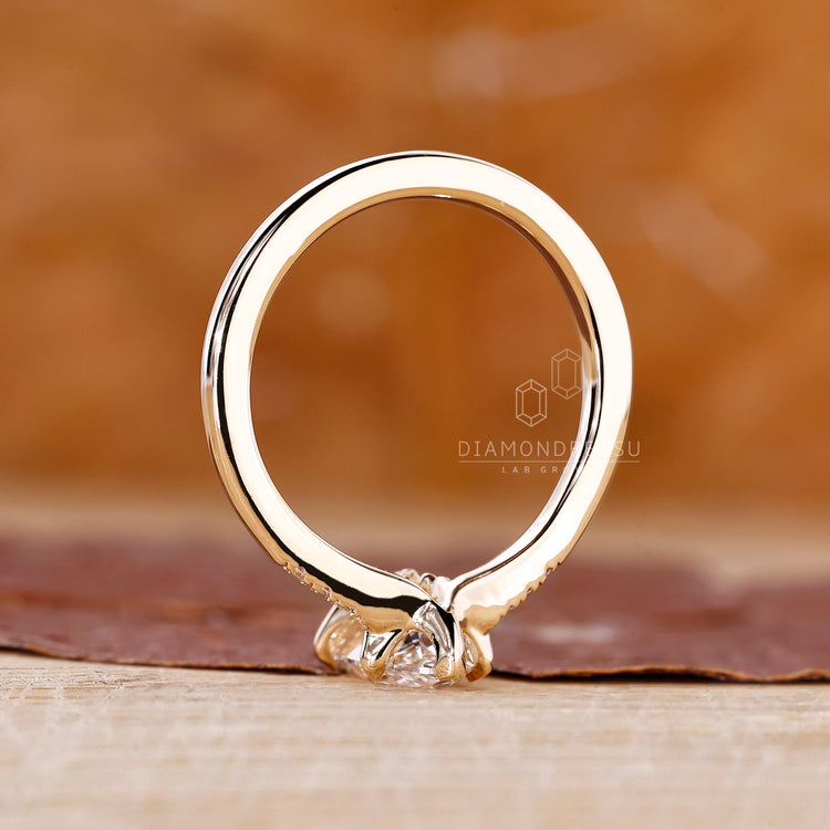 Handmade ring featuring tapered shank and side stones.