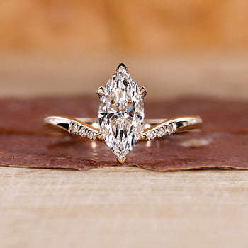 Yellow gold marquise diamond engagement ring with bold design.