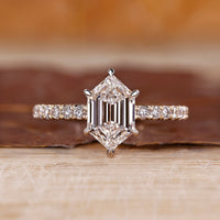 Hexagon diamond ring with hexagon step cut and pave setting.