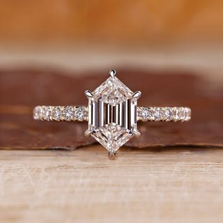 Hexagon diamond ring with hexagon step cut and pave setting.