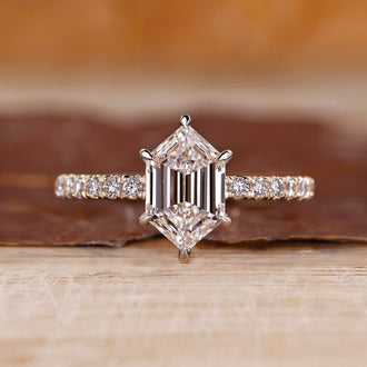 Hexagon diamond ring with hexagon step cut and pave setting.