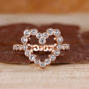 Heart shaped ring with round diamond in rose gold setting.
