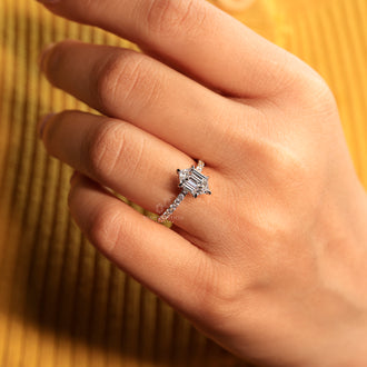 Pave setting ring with hexagon diamond and round cut pave band.