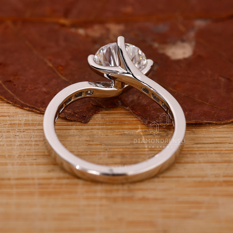 Elegant bypass engagement ring with smooth open design.