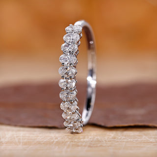 Woman wearing diamond solitaire engagement ring on white background